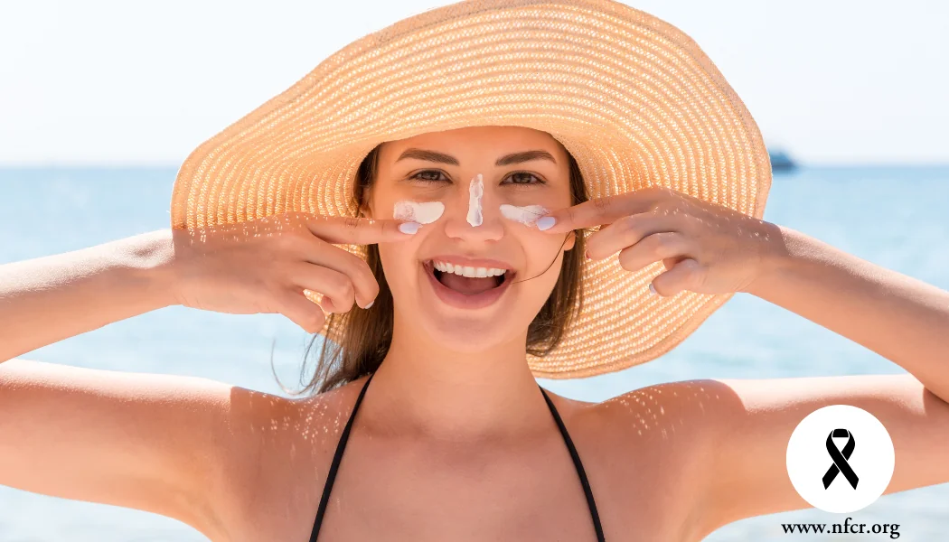 5 Tips to Prevent Melanoma (1) Woman applies sunscreen to face