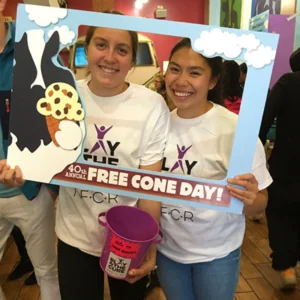 Square Get Involved Volunteer 2 volunteers pose with a photo prop